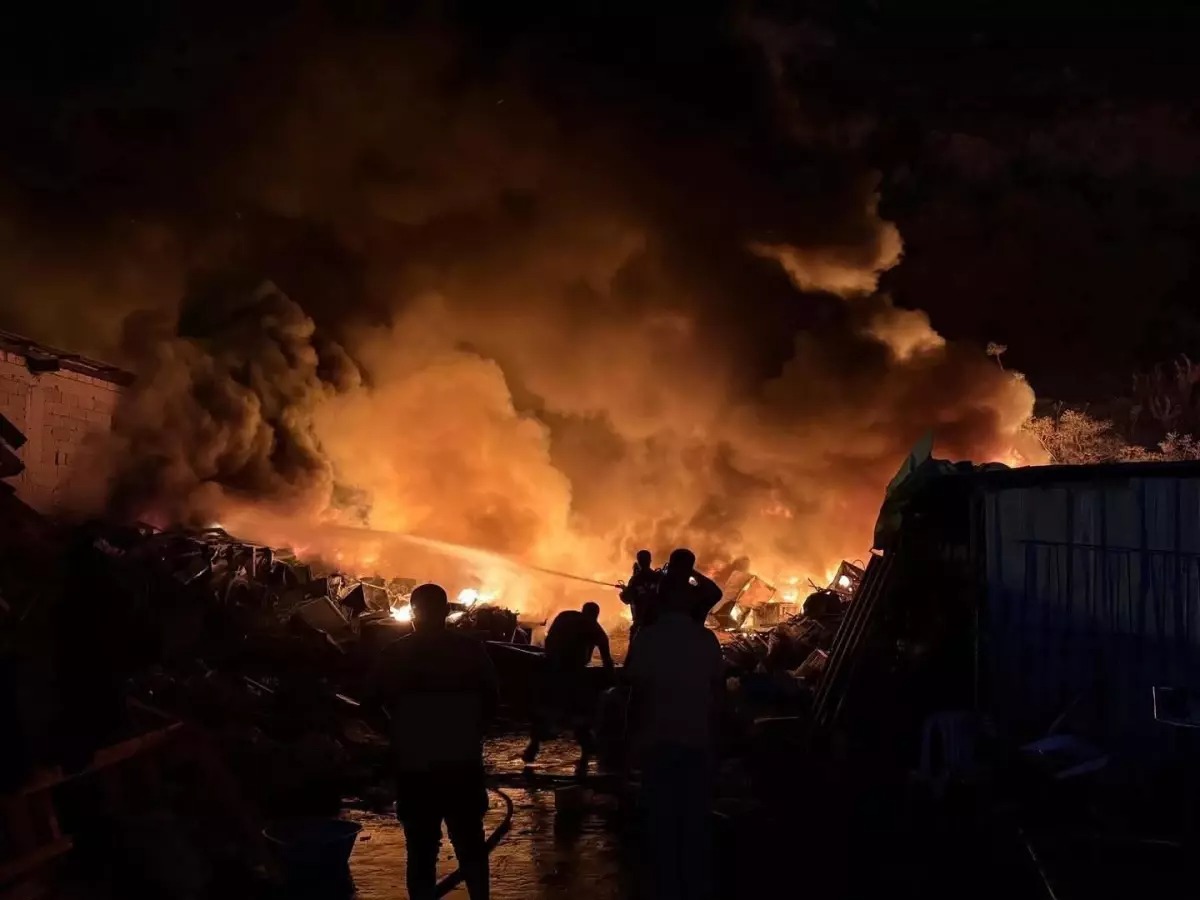 Hatay’ın Antakya ilçesinde bir hurdalıkta çıkan yangın, çevredeki ağaçlık alana
